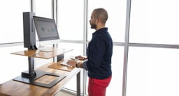 The E7 Electric Standing Desk Converter with effortless electric operation, available in over a dozen customization options