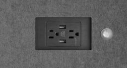 Two UL-certified 120V power outlets and two 2.1 amp USB ports are located below the height adjustable work surface