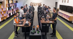Rooster Teeth Austin employees standing at their UPLIFT Desks