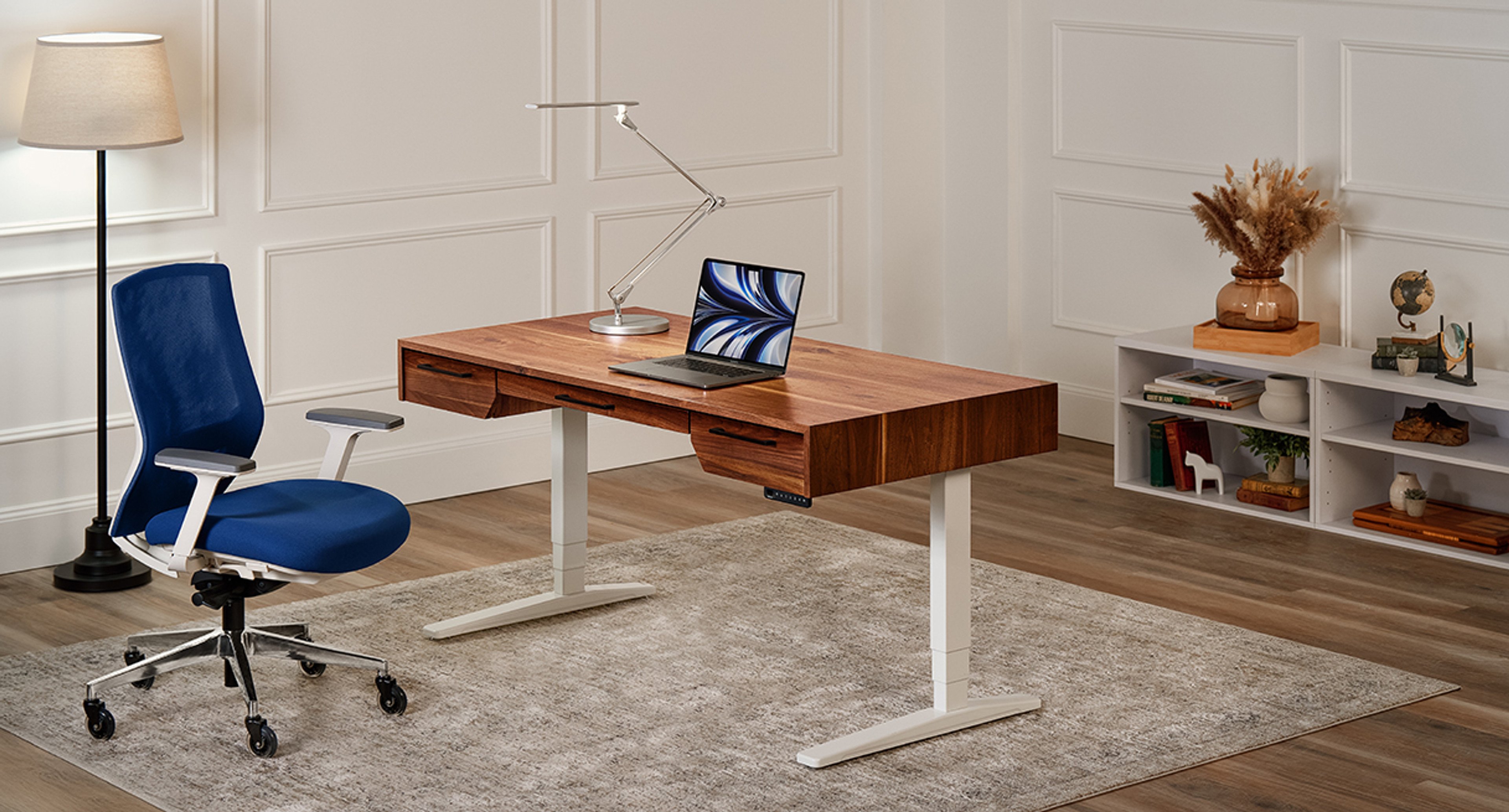 The Narrative Standing Desk is a handmade, solid wood desk with built-in drawers